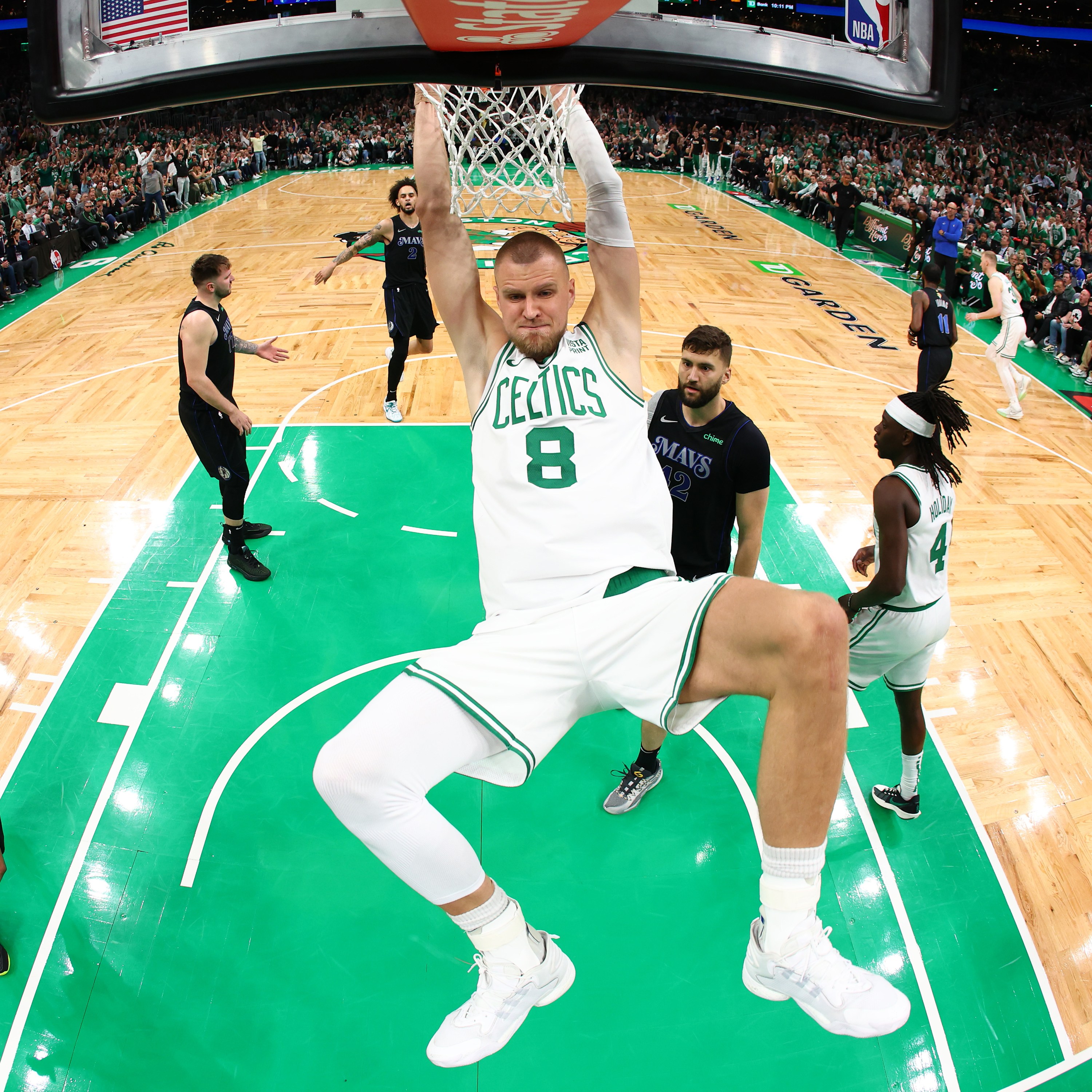 BOSTON, MASSACHUSETTS - JUNE 06: Kristaps Porzingis #8 of the Boston Celtics dunks the ball during the first quarter against the Dallas Mavericks in Game One of the 2024 NBA Finals at TD Garden on June 06, 2024 in Boston, Massachusetts. NOTE TO USER: User expressly acknowledges and agrees that, by downloading and or using this photograph, User is consenting to the terms and conditions of the Getty Images License Agreement. (Photo by Maddie Meyer/Getty Images)