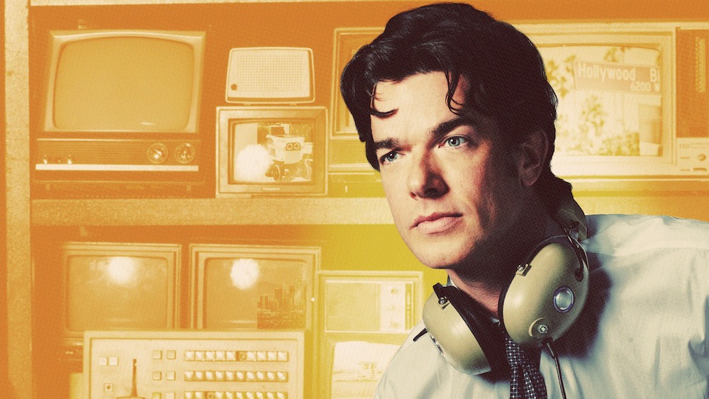 Still of John Mulaney with headphones press shot for Netflix