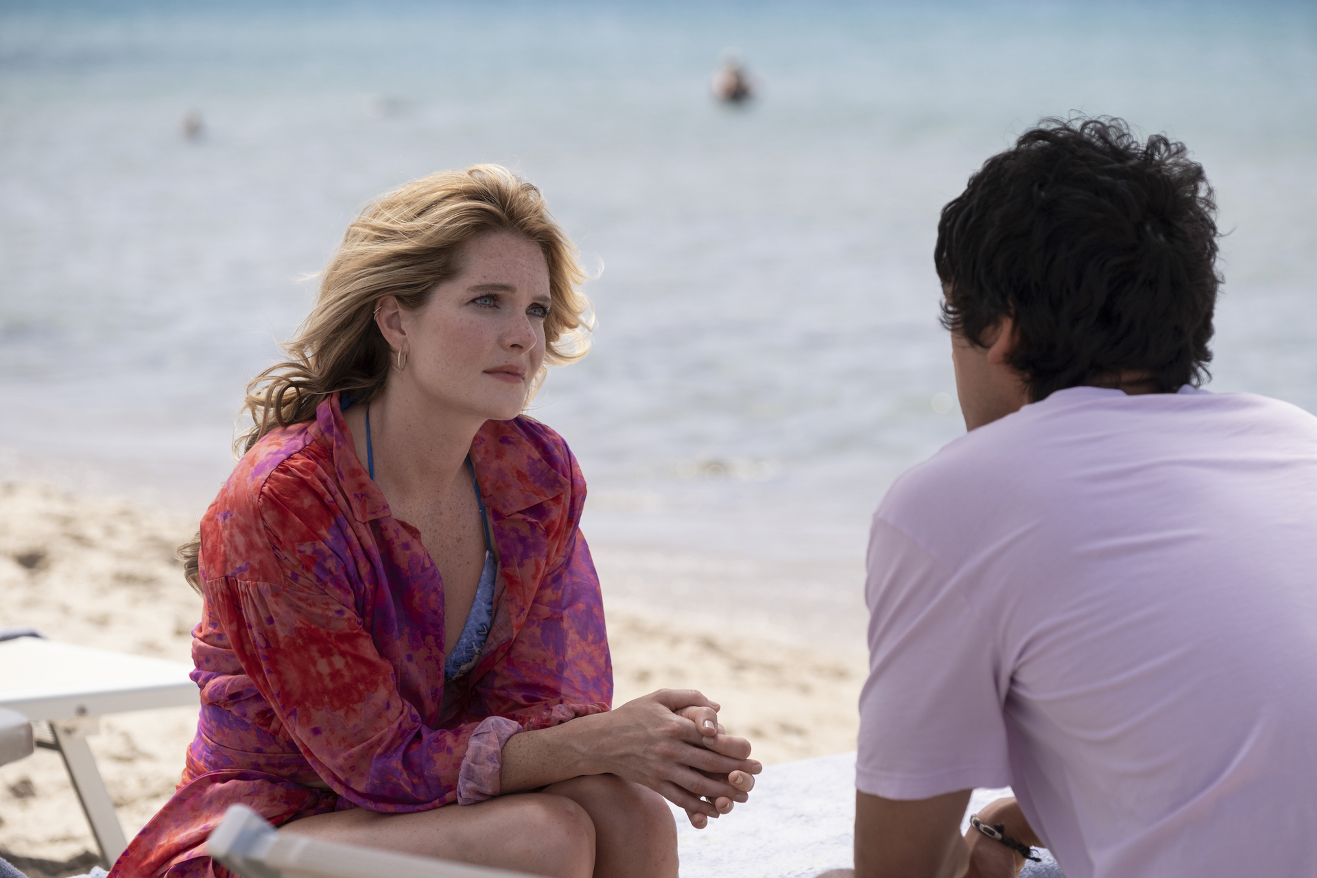 A man and woman speak on the beach; still from "The White Lotus"