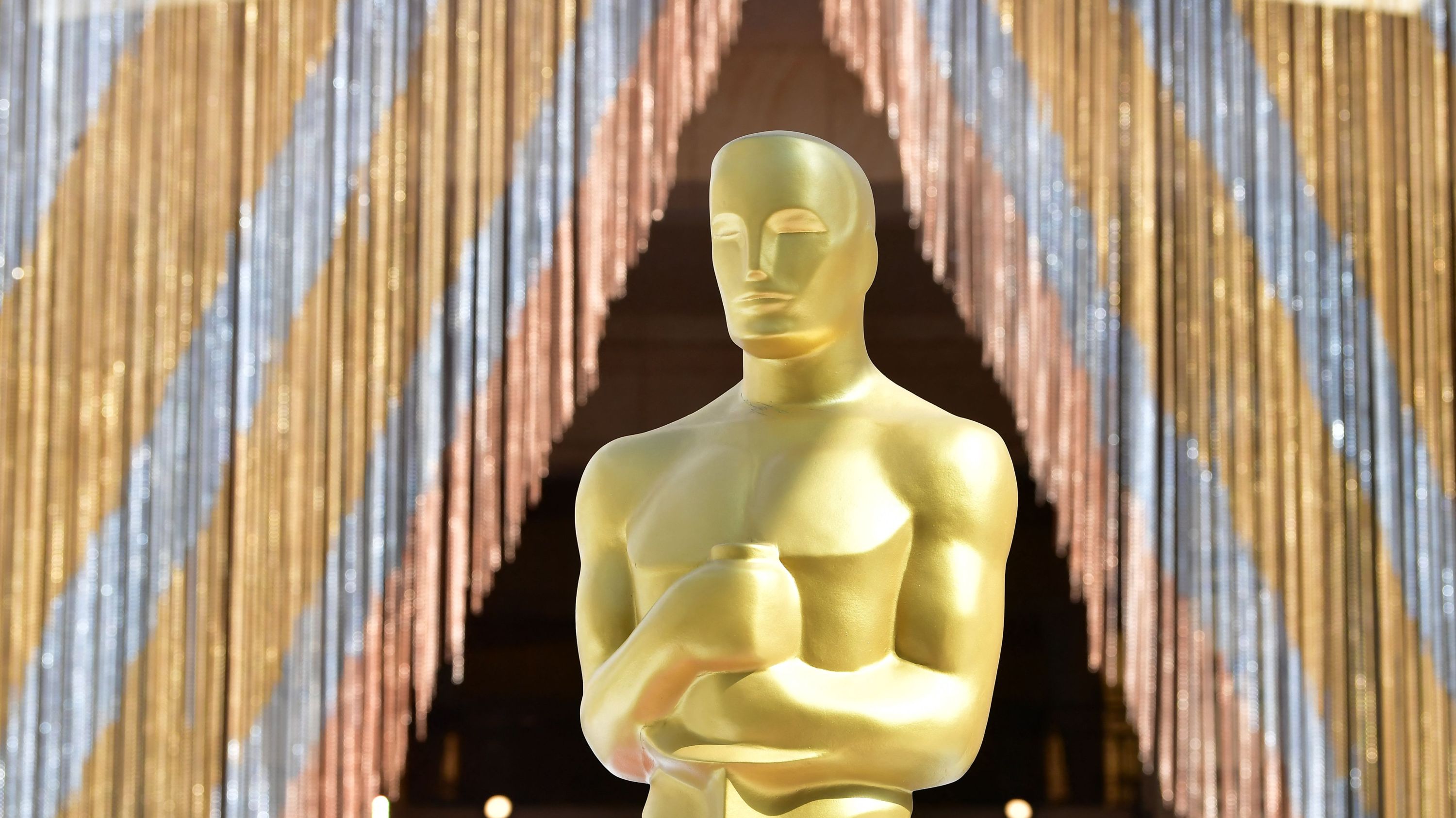 A statue of the Oscar is seen on a tarp-covered red carpet as preparations continue in the red carpet arrivals area along Hollywood Boulevard ahead of the 94th Academy Awards.